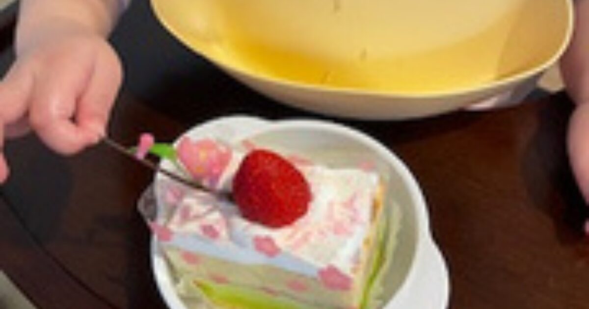 雛祭り子供用ケーキを食べている娘の手の様子